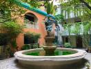 Outdoor courtyard with a fountain and lush greenery in an apartment complex