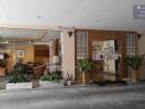 Entrance to a building with a view into a well-furnished lobby