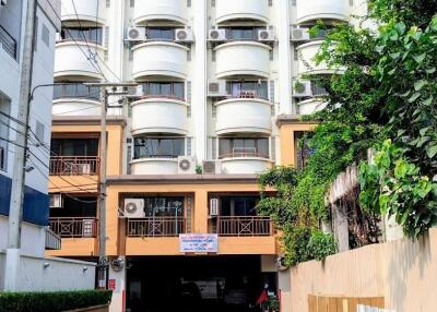 Front view of a multi-story residential building with balconies