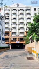 Front view of a multi-story residential building with balconies