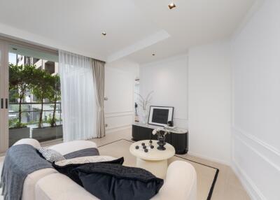 Modern living room with white walls, a large window, and contemporary furniture