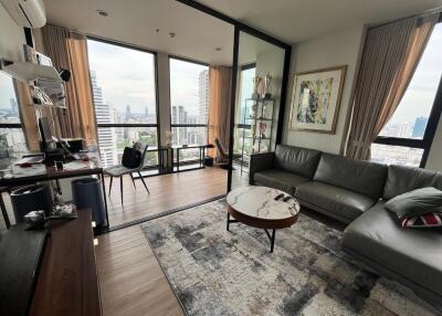 Modern living room with floor-to-ceiling windows and city view