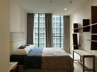 Modern bedroom with large windows and shelving