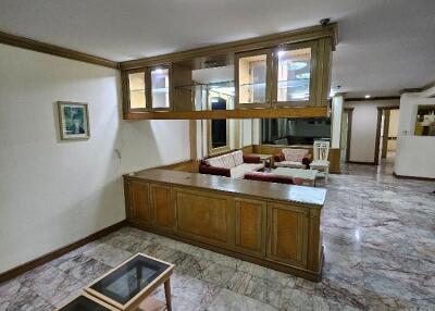 Living room with marble floor, wooden cabinetry, and sofas