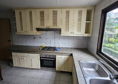 Modern kitchen with stovetop, oven, and double sink