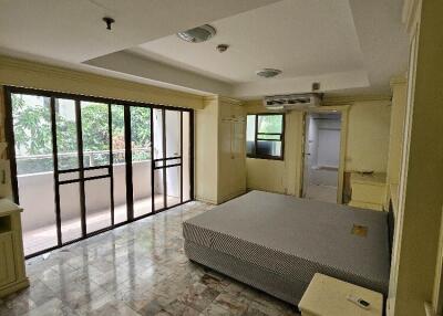 Bedroom with large windows and balcony access