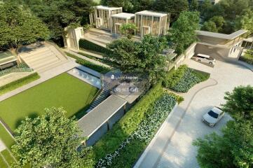 Aerial view of a modern residential building complex with landscaped gardens and driveways.