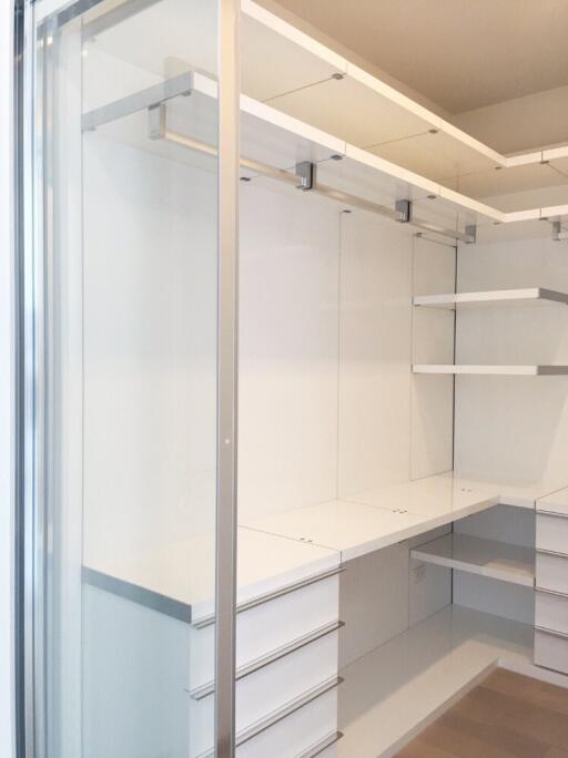 Modern walk-in closet with ample shelving and drawer space