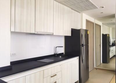 Modern kitchen with white cabinets and black countertop