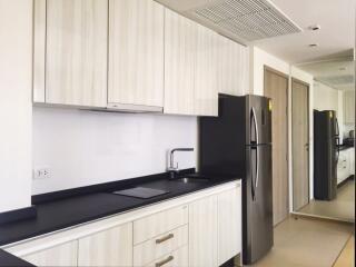 Modern kitchen with white cabinets and black countertop