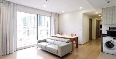 Bright living area with dining table and kitchenette