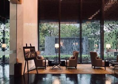 Modern living area with large windows and comfortable seating