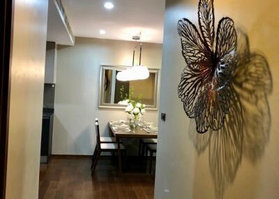 A hallway with a view towards a dining area