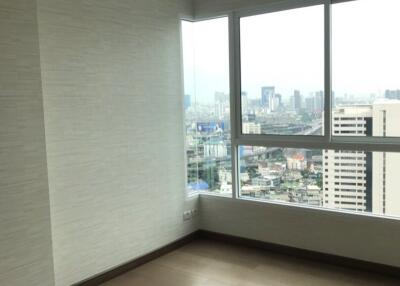 Spacious bedroom with large windows and city view