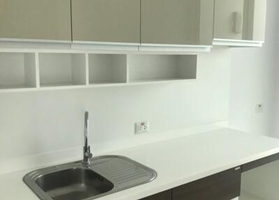 Modern kitchen with white countertops and brown cabinets