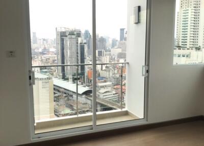 Living room with a view of the city through a large sliding glass door