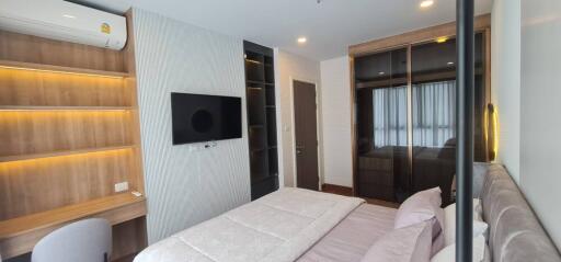 Bedroom with modern interior, featuring wardrobe and shelves