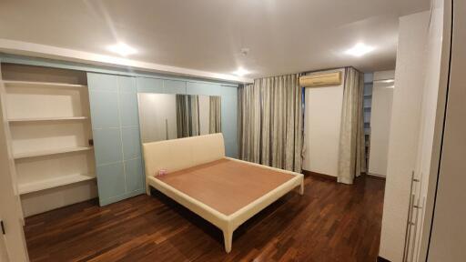 Spacious Bedroom with Wooden Flooring and Built-in Wardrobes