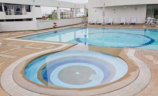 Outdoor swimming pool with lounging area