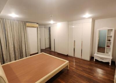 Spacious bedroom with large bed and wardrobe