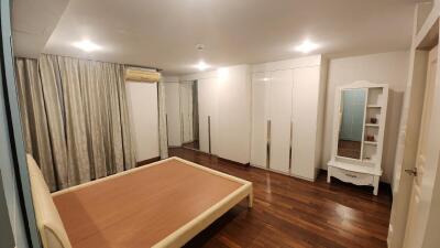 Spacious bedroom with large bed and wardrobe