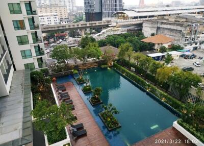 Aerial view of a modern apartment building with a swimming pool