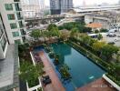 Aerial view of a modern apartment building with a swimming pool