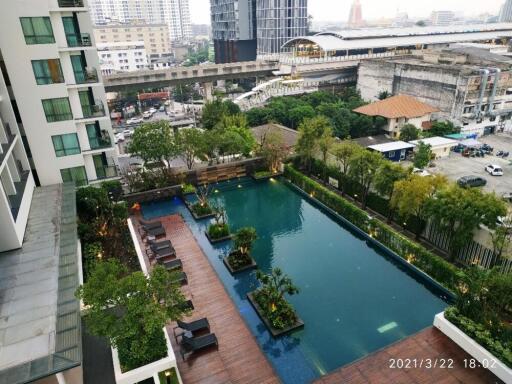 Aerial view of a modern apartment building with a swimming pool