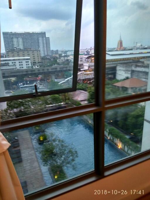 View from window showing cityscape and pool