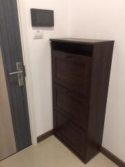 entryway with a shoe cabinet and wall-mounted device