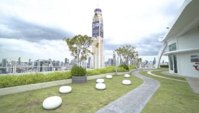 High-rise building with a landscaped terrace offering city views