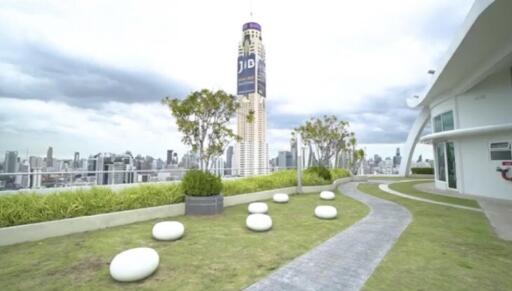 High-rise building with a landscaped terrace offering city views