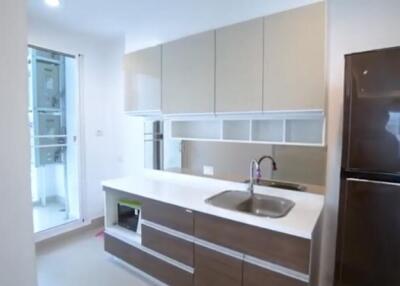 Modern kitchen with sleek cabinetry and large refrigerator