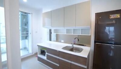 Modern kitchen with sleek cabinetry and large refrigerator