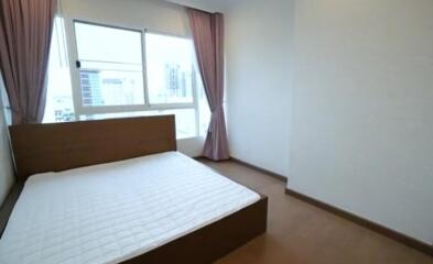 Spacious bedroom with large windows and natural light