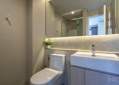 Modern bathroom with toilet, sink, and shower