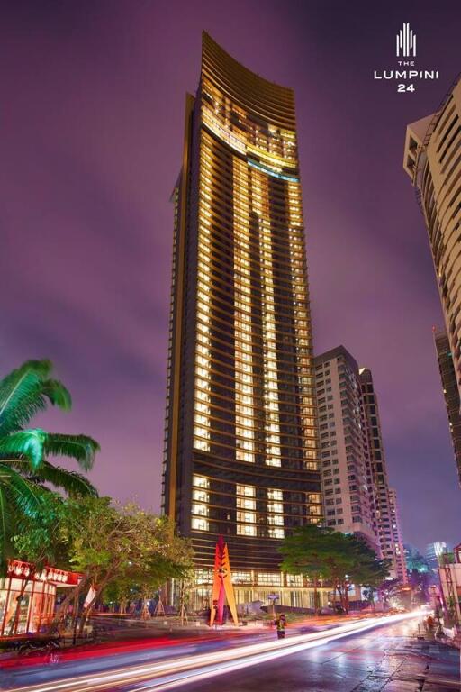 Modern high-rise building at nighttime with lights on