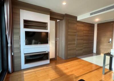 Modern living room with wooden flooring and large window