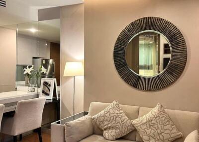 Modern living room with sofa, mirror, and dining area