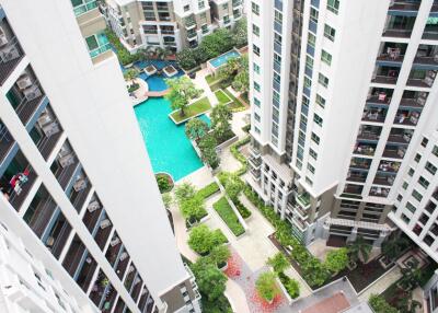 Aerial view of a residential apartment complex with a swimming pool