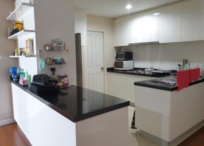 Modern kitchen with black countertops and white cabinetry