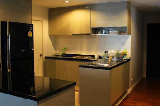 Modern kitchen with black countertops and sleek cabinetry