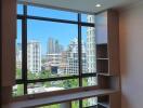 Room with large window overlooking city skyline