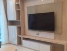 Modern living room with mounted TV and built-in storage