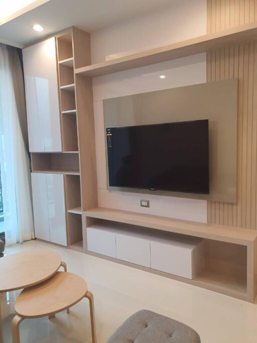 Modern living room with mounted TV and built-in storage