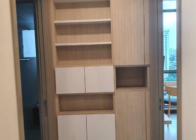 Hallway with built-in storage cabinets and shelves