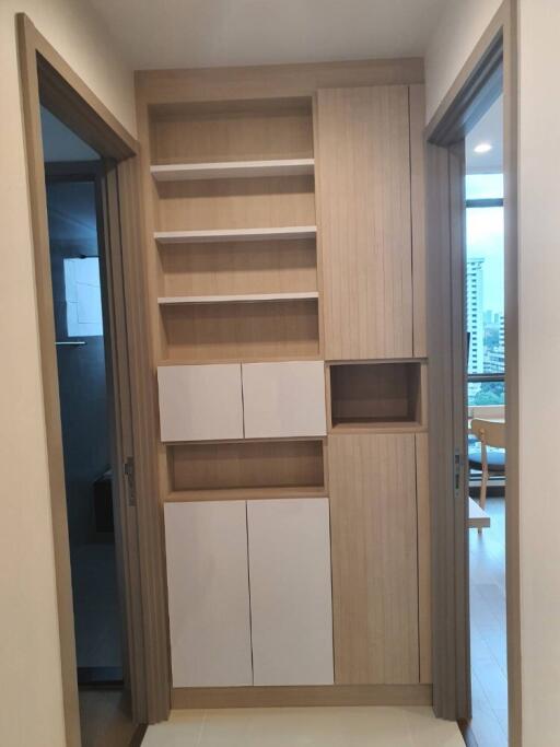 Hallway with built-in storage cabinets and shelves