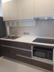 Modern kitchen with built-in appliances and white countertop