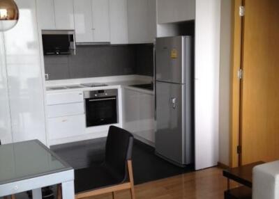 Modern kitchen with white cabinets and stainless steel appliances