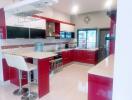 Modern kitchen with red cabinets and breakfast bar